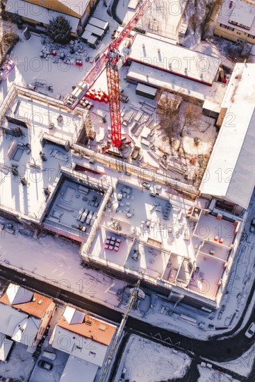 Detailed view of a snowy construction site with visible building materials, Zellerschule new building, Nagold, Black Forest, Germany