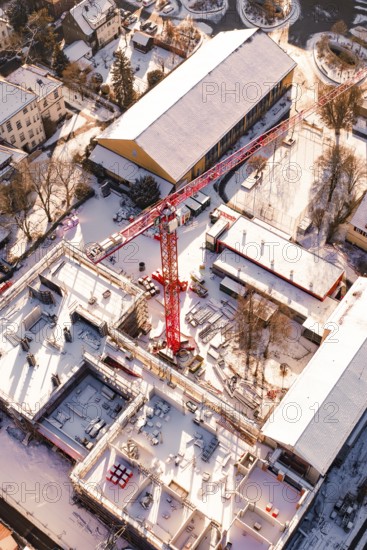 Detailed aerial view of a construction site in a snowy urban landscape, Zellerschule building, Nagold, Black Forest, Germany