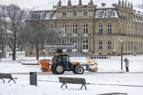 Winter in Stuttgart. There is a closed blanket of snow in the city center. Winter cleaning service on Schlossplatz in front of the New Palace. Roads and paths are freed from snow and sprinkled. Stuttgart, Baden-Württemberg, Germany