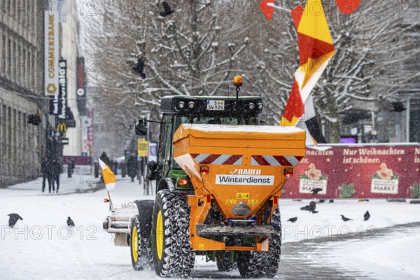 Winter in Stuttgart. There is a closed blanket of snow in the city center. Winter cleaning service at Schlossplatz. Roads and paths are freed from snow and sprinkled. Stuttgart, Baden-Württemberg, Germany