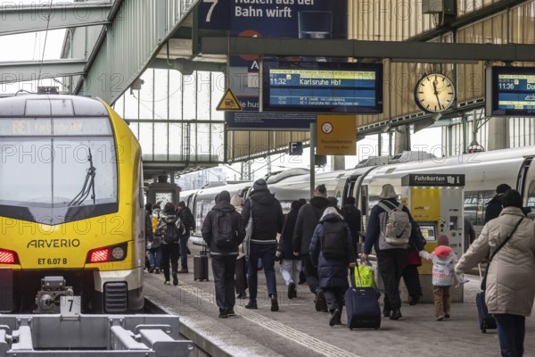 Travelers in the main train station, passengers in front of a regional train from Arverio. Zugzielanzeiger at Stuttgart Central Station, Stuttgart, Baden-Württemberg, Germany