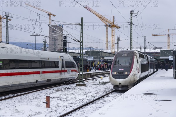 Winter in Stuttgart. There is also a closed layer of snow in the main train station. Station building with ICE and TGV. Stuttgart, Baden-Württemberg, Germany