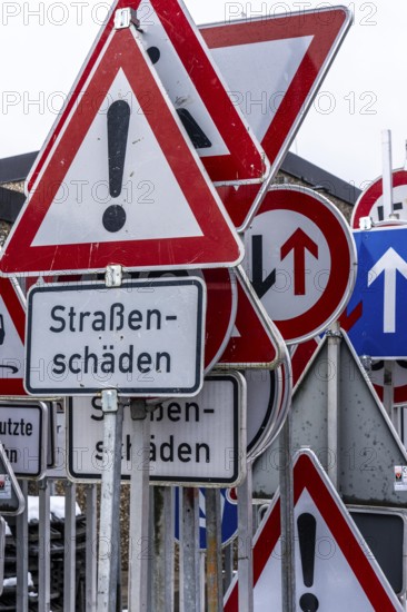 Storage for traffic signs in the yard of a road maintenance department, various signs with commandments and prohibitions, information about dangers, road traffic