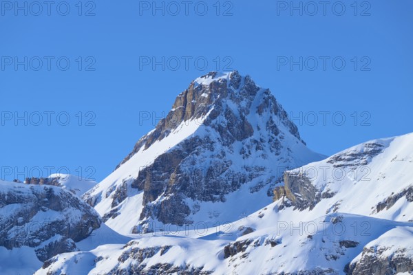 Snowy mountain peak under clear blue sky surrounded by rocks, Gemmi Pass, Leukerbad, Leuk, Valais, Switzerland
