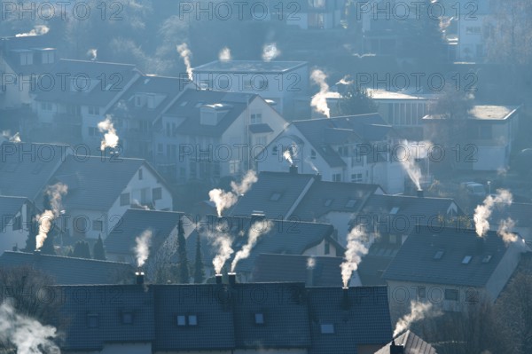 Cold winter morning view of a settlement with numerous smoking chimneys, symbolic image, fireplaces, gas heating, oil heating, fossil fuels, climate change, global warming, chimneys, Baden-Württemberg, Germany
