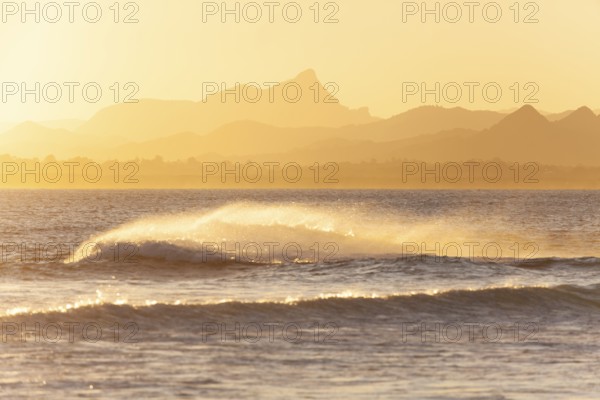 Evening light at Cape Byron with view to Mount Warning and sunlit hinterland, New South Wales, Australia