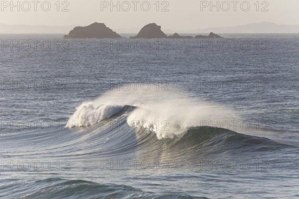 Looking towards Julian Rocks Nature Reserve across the breaking waves. Ocean view, Byron Bay, New South Wales, Australia