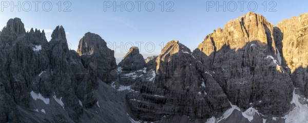 Aerial view, alpine panorama, Cima Tosa and rocky peaks at sunrise with alpine glow, picturesque mountain landscape, Brenta Dolomites, Trentino, Italy