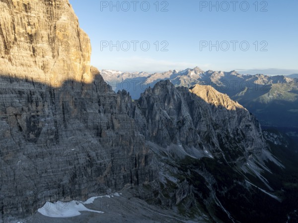 Aerial view, alpine panorama, rocky peaks at sunrise with alpine glow, picturesque mountain landscape, Brenta Dolomites, Trentino, Italy
