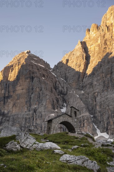 Cappella Ai Brentei chapel Memorial for injured mountaineers at the Rifugio Ai Brentei mountain hut, rocky peaks at sunrise with alpine glow, picturesque mountain landscape, Brenta, Trentino, Italy
