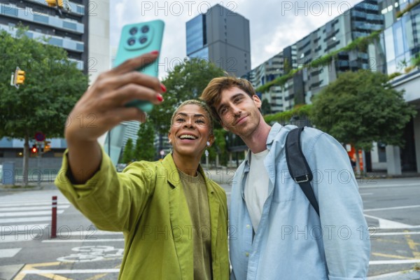 Smiling multiracial young adults enjoying a moment together outdoors, capturing a selfie with a smartphone, representing connection, joy, and urban lifestyle