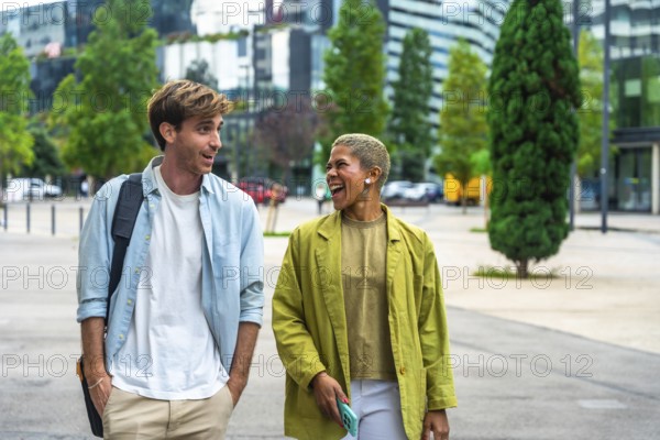 Diverse colleagues cheerfully engaging in conversation while walking together through a modern urban environment, symbolizing teamwork, communication, and shared success in a dynamic city setting