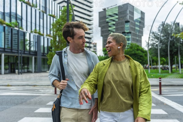 Engaging diverse colleagues walking across a city crosswalk, sharing a moment of laughter while commuting between modern office buildings, representing collaboration and urban lifestyle