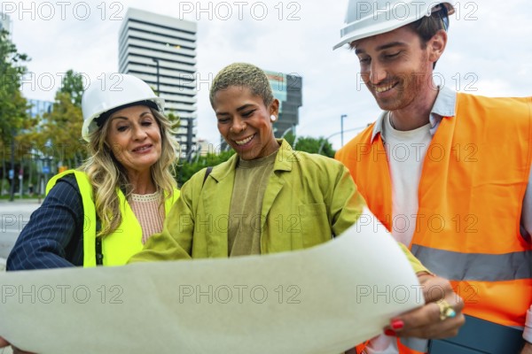 Diverse team of architects and construction professionals collaborating and discussing building plans, ensuring safety and progress in an urban construction project