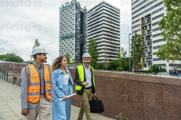 Diverse team of engineers and executives wearing safety vests and hard hats walking outdoors in a modern city street, discussing construction plans and urban development