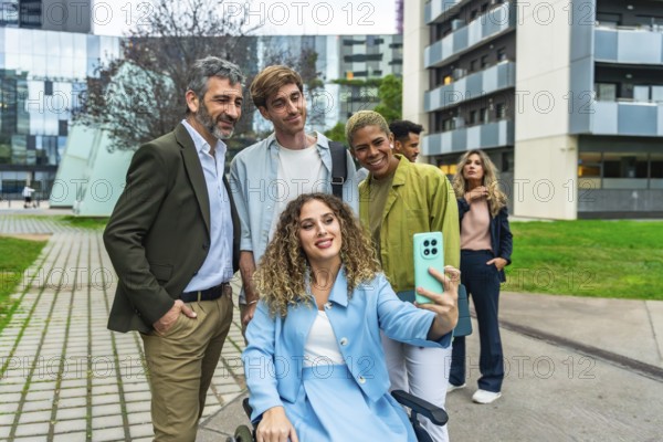 Diverse business team, including a woman in a wheelchair, smiling and taking a cheerful outdoor selfie in the city, symbolizing inclusion, teamwork and modern workforce collaboration