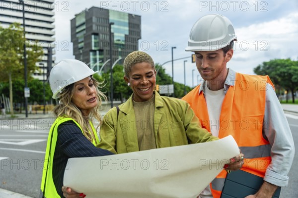 Diverse group of engineers and architects collaborating on an outdoor construction site, discussing project plans, safety, and urban development while wearing hard hats and safety vests