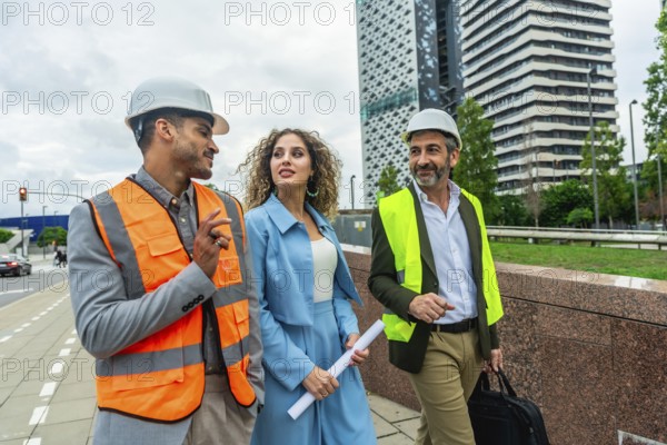 Construction professionals and architects walking outdoors in a modern city, discussing building plans and urban development, wearing safety vests and hard hats