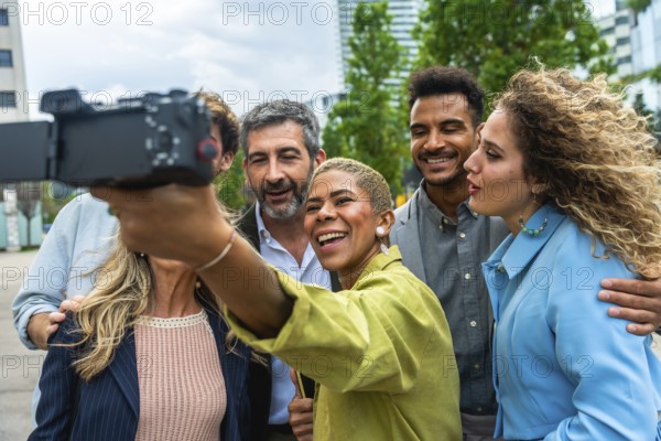 Diverse group of smiling business professionals vlogging outdoors, capturing content together for online sharing, representing connection, teamwork, and modern communication in an urban setting