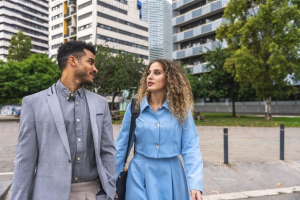 Business colleagues having a discussion while walking through a contemporary urban area, presenting teamwork, networking, and professional interaction in a modern city setting