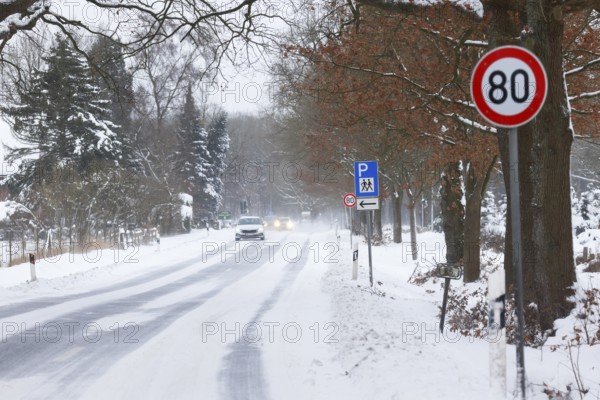 Road traffic in winter, icy road covered with snow with car traffic, risk of accident, Schleswig-Holstein, Germany