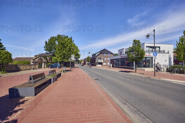Commercial buildings, houses, general architecture, Landessparkasse zu Oldenburg, benches, lantern, paving brick sidewalk, trees, blue sky, cirrus clouds, Osnabrücker Straße, district of Vörden, Neuenkirchen-Vörden, district of Vechta, Lower Saxony, Germany