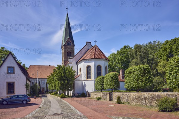 St. Paul's Church, general architecture, building, concrete paving stone walkway, paving stones and natural stones, sandstone wall, trees, blue sky, cirrus clouds, Am Burghof, district of Vörden, Neuenkirchen-Vörden, Vechta district, Lower Saxony, Germany