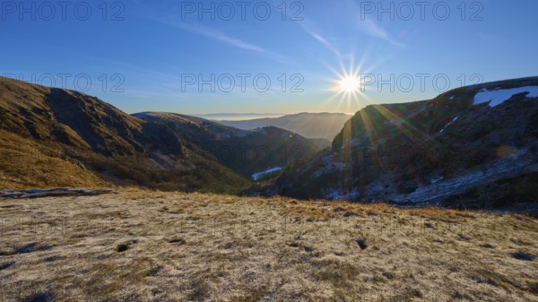 Frost-covered mountain landscape at sunrise with clear sky and bright sunlight, winter, Route de Cretes, Hohneck, La Bresse, Vosges, France
