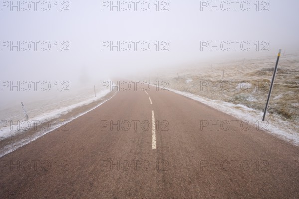 Winding road hidden in thick fog, winter, Route de Cretes, Hohneck, La Bresse, Vosges, France