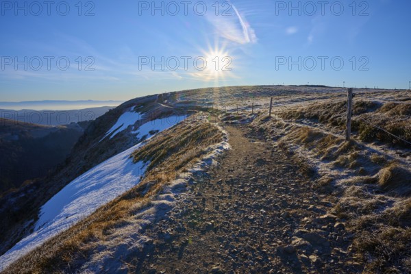 Snowy trail on a ridge at sunrise, clear view with frosty landscape, winter, Route de Cretes, Hohneck, La Bresse, Vosges, France