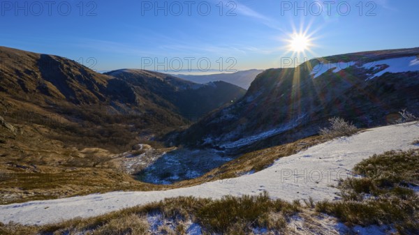 Snowy mountain landscape at sunrise, mountainous valley with clear sky, winter, Route de Cretes, Hohneck, La Bresse, Vosges, France