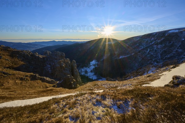 Sunrise over a snow-covered valley surrounded by mountains and rocks, winter, Route de Cretes, Hohneck, La Bresse, Vosges, France