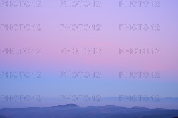 Mountain range under a calming sky in pastel shades of purple, pink and blue, looking at, Rhine Valley, Hohneck, La Bresse, Vosges, France