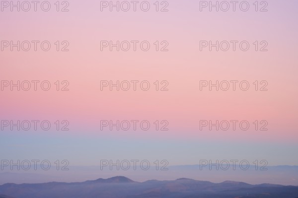 Mountains under a clear sunset sky in pastel shades of pink, purple and blue, viewing, Rhine Valley, Hohneck, La Bresse, Vosges, France