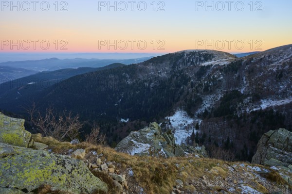 Snowy hills and rocks in warm evening light, view of the Rhine Valley, viewpoint, La Gorge de Pierrel, Martinswand, Frankental, Vosges, France