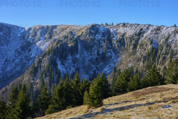 Snowy rock face with trees below in bright sky, viewpoint, Martinswand, Frankental, Vosges, France