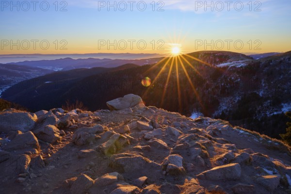 Rocks on a mountain peak at dawn under a setting sun, looking towards the Rhine Valley, viewpoint, La Gorge de Pierrel, Martinswand, Frankental, Vosges, France