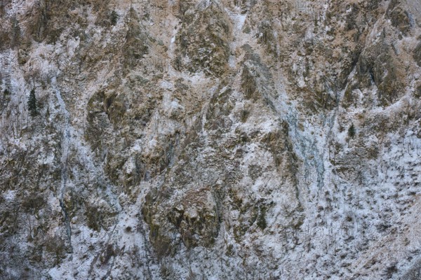 Rocky, snowy mountain wall with complex texture and cold winter atmosphere, Hohneck, La Bresse, Vosges, France