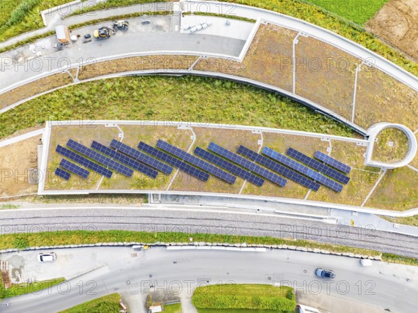 Solar panels on a flat roof surrounded by roads and vegetation, new park and ride car park Calw Heumaden on the new Hermann Hessebahn, Calw, Germany