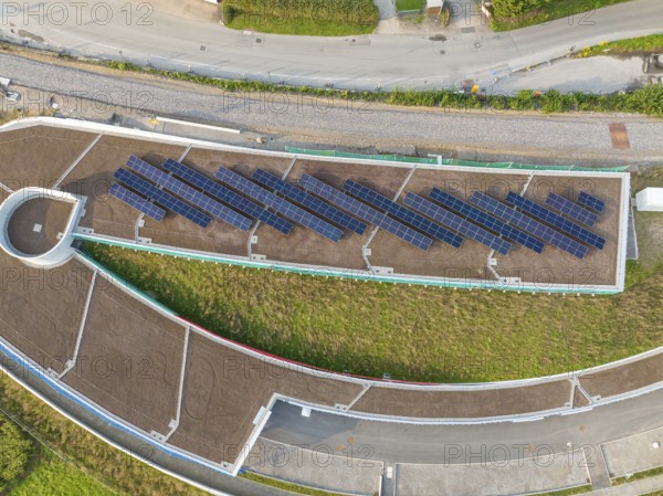 Aerial view of a solar roof in an urban area surrounded by roads, new park and ride parking garage Calw Heumaden on the new Hermann Hessebahn, Calw, Germany
