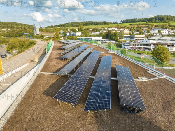 Solar module field in an urban environment with green landscape in the background, new park and ride parking garage Calw Heumaden on the new Hermann Hessebahn, Calw, Germany