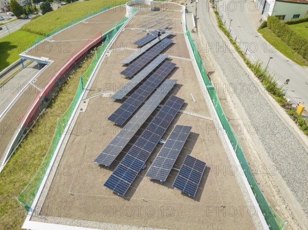 Solar panels on a green roof, surrounded by roads and buildings, new Park and Ride Calw Heumaden car park on the new Hermann Hessebahn, Calw, Germany