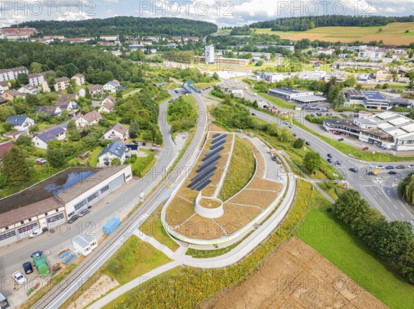 Wide view of an area with solar systems, surrounded by residential and commercial areas, new park and ride parking garage Calw Heumaden on the new Hermann Hessebahn, Calw, Germany