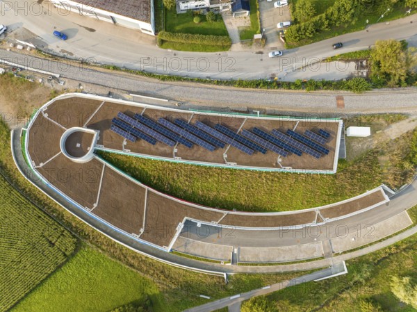 Aerial view of a solar cell field on a roof with surrounding roads, new Park and Ride parking garage Calw Heumaden on the new Hermann Hessebahn, Calw, Germany