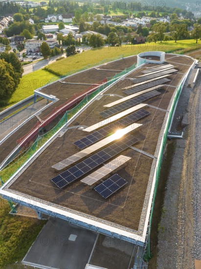 A roof area with solar panels, illuminated by the evening sun, in a rural area, new park and ride parking garage Calw Heumaden on the new Hermann Hessebahn, Calw, Germany