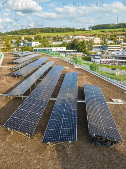 Rows of solar modules with views of the surrounding area and green hills, new Park and Ride Calw Heumaden car park on the new Hermann Hessebahn, Calw, Germany