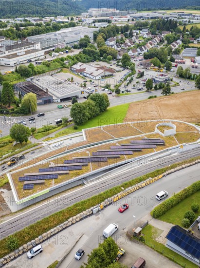 View of urban landscape with solar panels and road traffic, new park and ride car park Calw Heumaden on the new Hermann Hessebahn, Calw, Germany