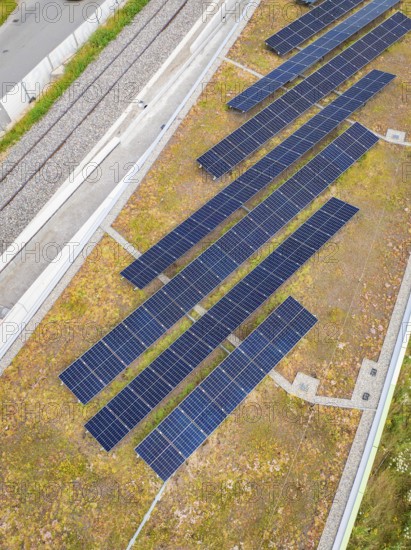 Roof area with several solar modules, surrounded by vegetation and rails, new Park and Ride Calw Heumaden car park on the new Hermann Hessebahn, Calw, Germany