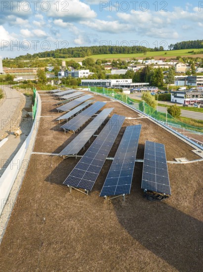 Solar panels on a hill roof with a view of rural surroundings and buildings, new park and ride parking garage Calw Heumaden on the new Hermann Hessebahn, Calw, Germany