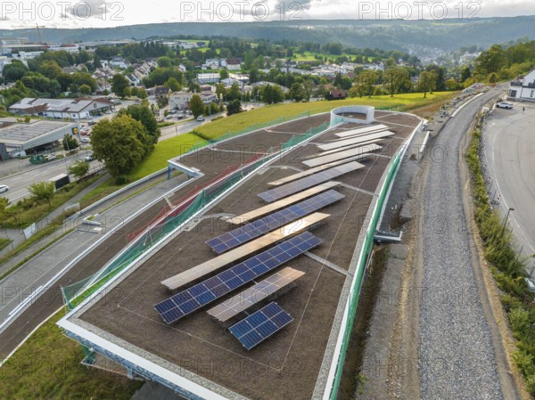 Expanded solar system on a roof with a view of a green landscape and city, new park and ride parking garage Calw Heumaden on the new Hermann Hessebahn, Calw, Germany